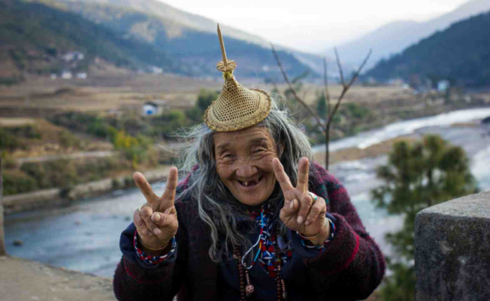 Bhutanese traveller beside a mountain river